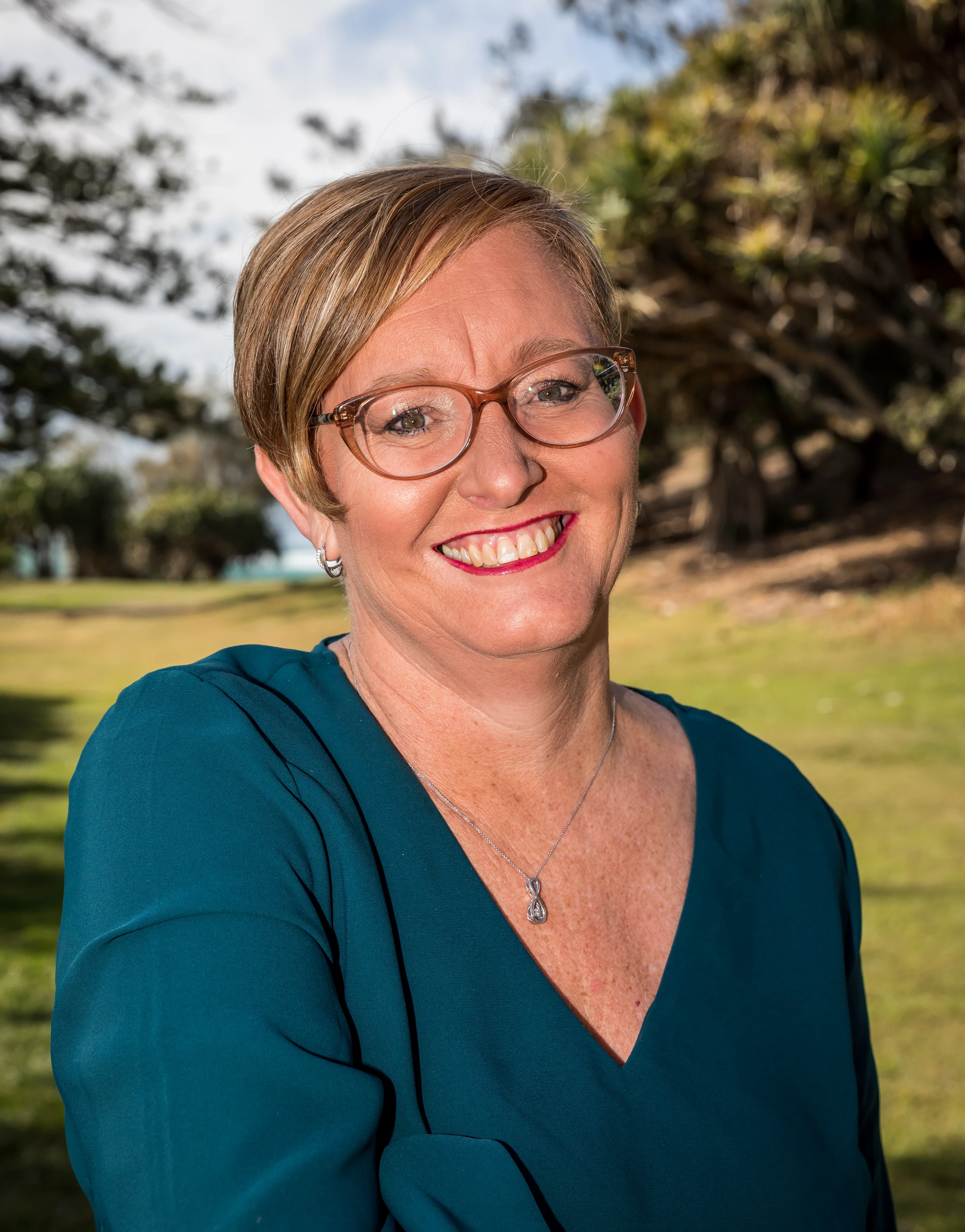 Smiling and professional lady in a park